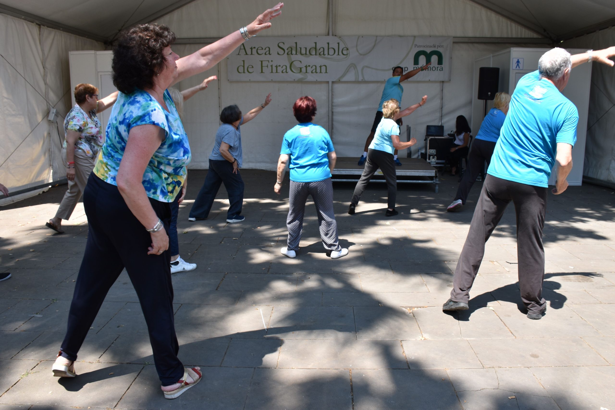 Grupo de personas mayores con un entrenador de Siel Bleu haciendo una sesión de ejercicio al aire libre